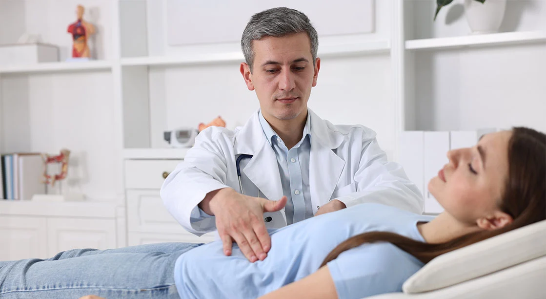 doctor examinando el estómago de paciente